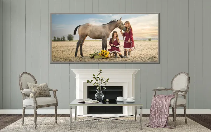 Framed family portrait of four people walking a tree-lined autumn path, hung above a console table.