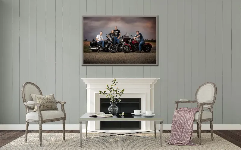 Framed family portrait of four people walking a tree-lined autumn path, hung above a console table.